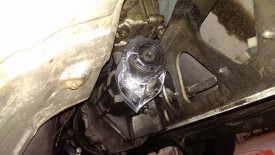 Plastic bag and rubber band over rear of transmission prevents dripping
