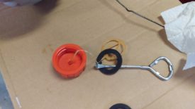 Simply pulls off with a screwdriver or this paint can opener