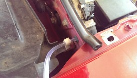 Hose can go through the firewall here in this grommet