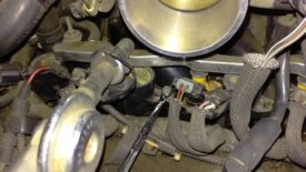 Using a box wrench to remove the COP bolt