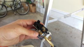 Undo the lock nut holding the cable