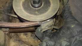 Pulling back on the detent to slip the belt on the pulley