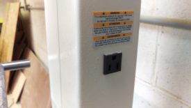 There's a 115 plug on the back of the post