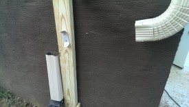 2x4 screwed to wall after lining up the downspout bracket