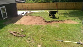 Using a shovel to level the ground out