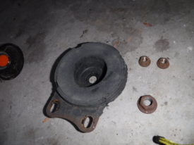 Retaining plate and three nuts from one side
